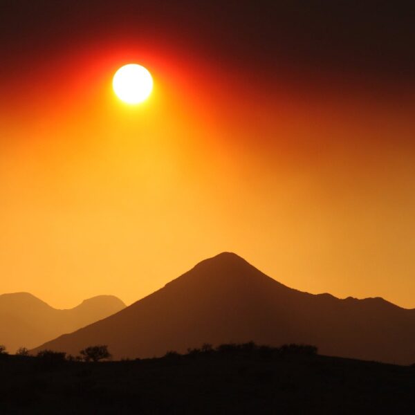 backlit clouds dawn desert