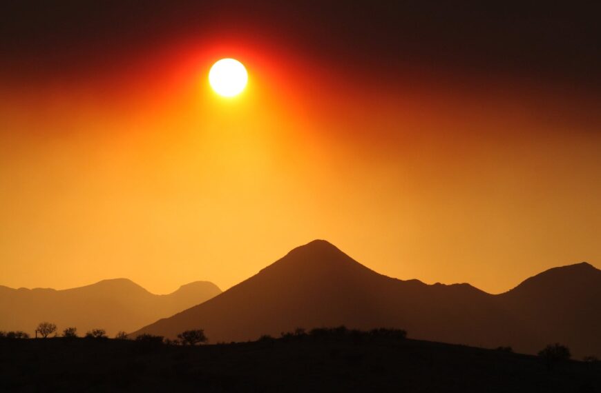 backlit clouds dawn desert