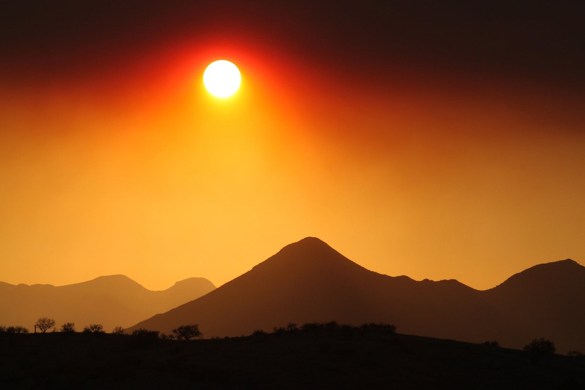 backlit clouds dawn desert