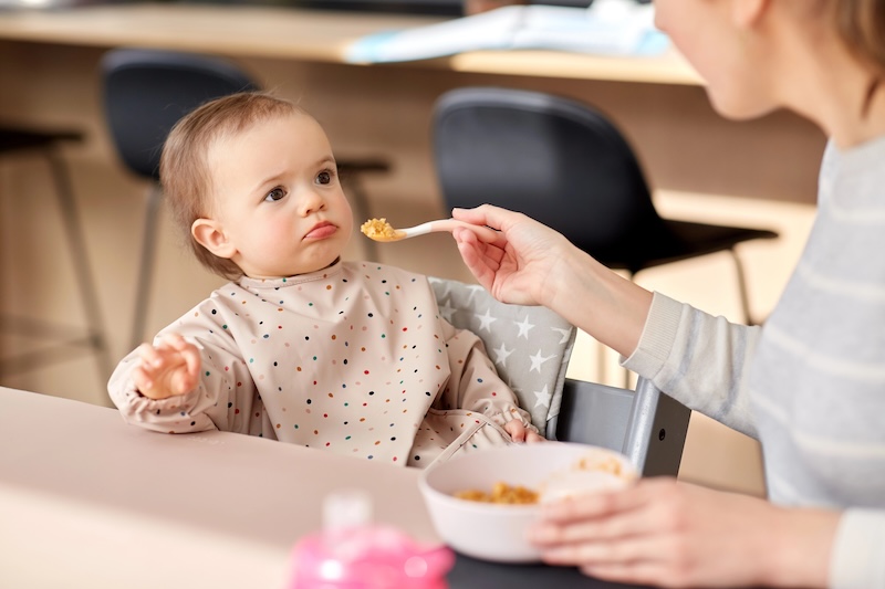 baby eating unsure of what's offered