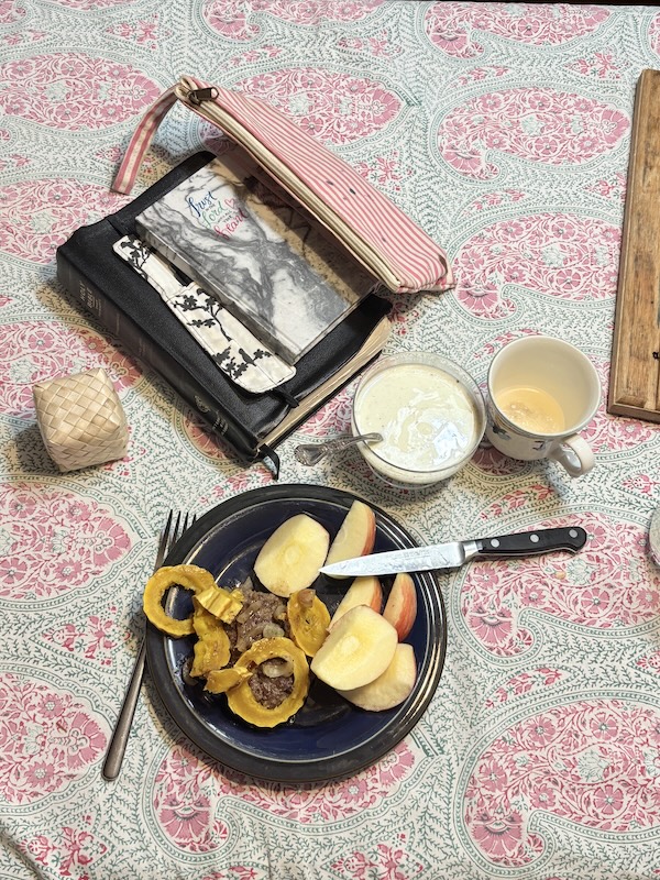 High protein breakfast with a burger, squash and apple.  A bowl of yougurt with seasoning and a cup of tea